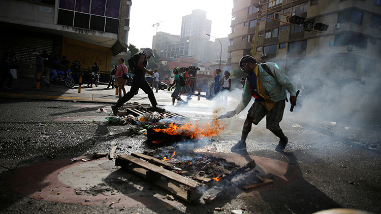 Ministro venezolano: Encapuchados prenden fuego a un joven tras confundirlo con un chavista