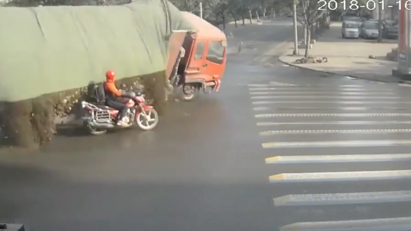 VIDEO: Un motociclista se libra por poco de morir sepultado por la carga de un camión 