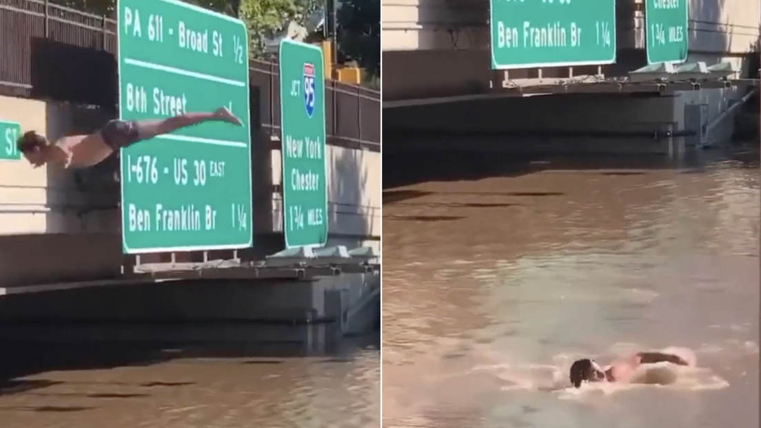 Hombre realiza un salto de espalda en las aguas que inundan una carretera en Filadelfia (VIDEO)