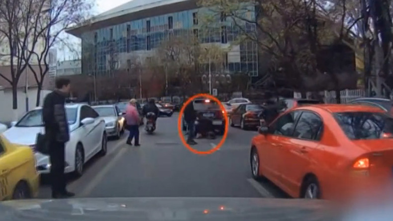 Angry biker kicks over jaywalker in China (VIDEO)