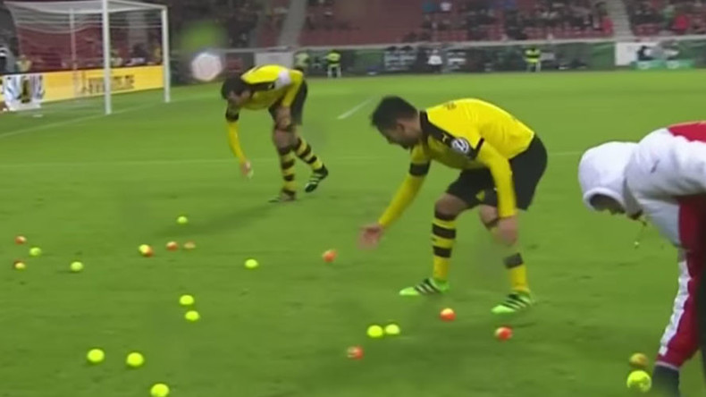 Borussia Dortmund fans hurl tennis balls onto pitch in ticket price protest (VIDEO)
