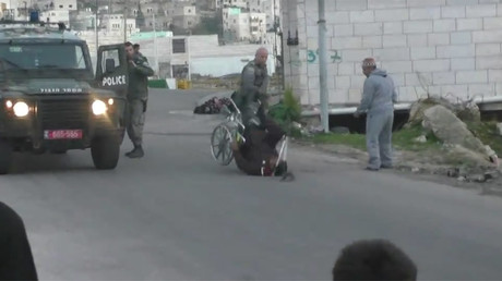 Israeli border police officer flips Palestinian man from wheelchair (VIDEO)