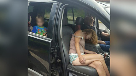 US police shame drug users with shocking photo of them passed out with child in backseat