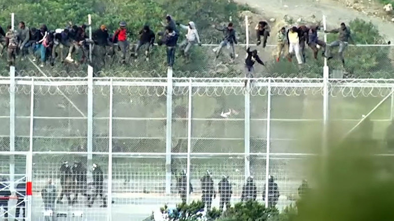 ‘Extremely violent, organized:’ 1,000 migrants storm Spanish enclave bordering Morocco (VIDEO)