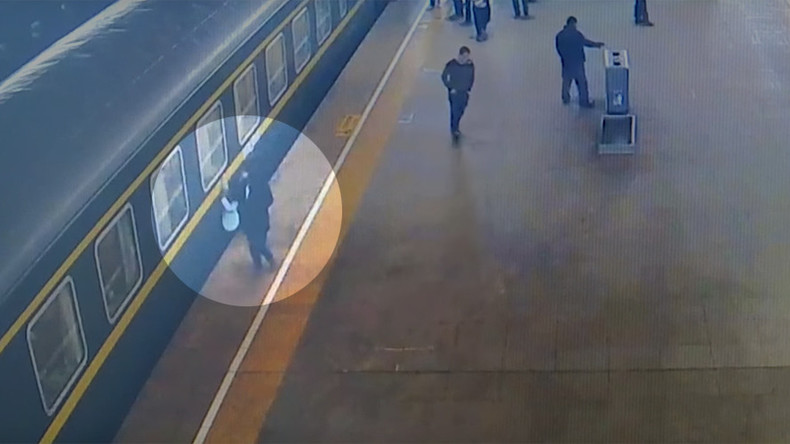 Stomach-churning moment 3yo falls under train at Chinese station caught on camera (VIDEO)