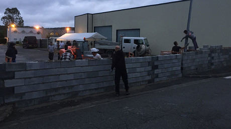 French protesters build wall around former hotel set to become migrant shelter