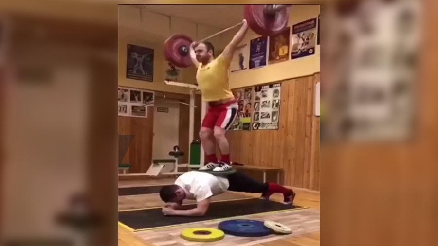 Under pressure: Man does plank with 200kg powerlifter and barbell on his back (VIDEO)