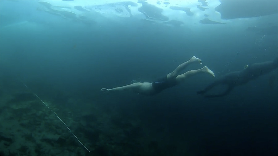 Breaking the ice! Russian chill-seeker dives into freezing waters of Lake Baikal (VIDEO)