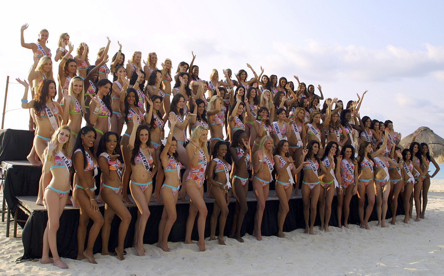 Contestants pose for a group photo for the swimsuit section of the Miss Uni...