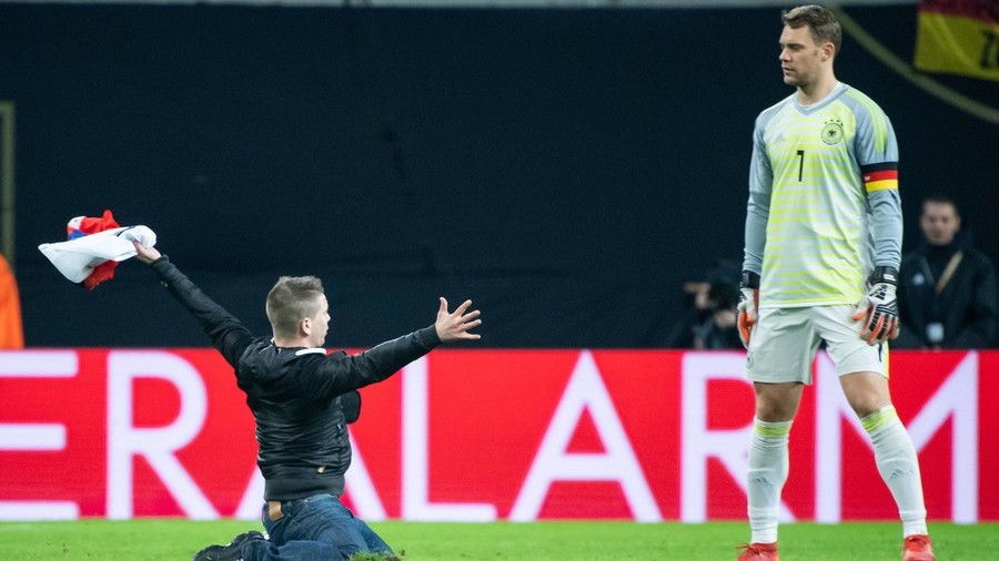 ‘I hope he wasn’t proposing’: Bizarre pitch invader knee-slides to Neuer in Russia v Germany game