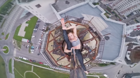 Working out HIGH: Extreme dancer performs atop 16-storey building on SLIPPERY pole (VIDEO)