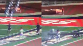 Referee dodges death as 80ft light pole crashes onto him at high school game (VIDEO)