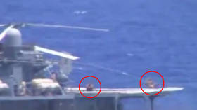 No bother to them: Russian sailors spotted SUNBATHING during near collision with US destroyer