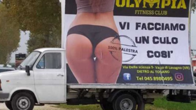 ‘Can’t a woman show a nice, muscular bottom?’ Italian fitness club owner denies its body-praising banner is sexist