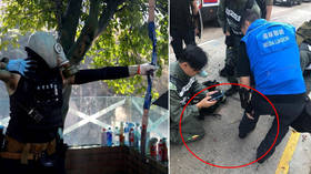 Hong Kong protesters hurl PETROL BOMBS at volunteers trying to clear roadblocks and shoot ARROWS at police
