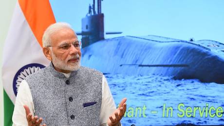 INS Arihant is seen on a screen behind India's Prime Minister Narendra Modi.