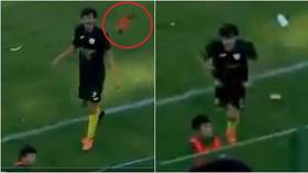Sticking the boot in: Tunisian footballer sent off for attacking cheeky ball boy who chucked his boot into crowd (VIDEO)