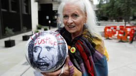 'They're playing football with his HEAD': Fashion icon Westwood holds up BALL outside court as she DEMANDS Assange freedom (VIDEO)