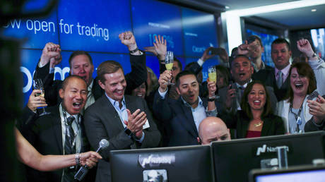 FILE PHOTO: Employees reacts as Jay Heller, head of capital markets & initial public offering (IPO) execution of Nasdaq Inc, center, opens trading on Zoom Video Communications Inc. during the company's IPO at the Nasdaq MarketSite on April 18, 2019 in New York City