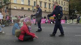 ‘Shame on you Finland! How dare you!’ Outrage as Helsinki police PEPPER SPRAY sitting XR protesters