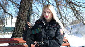 Siberian woman dubbed Russia's 'most beautiful police officer' sues service in bid to win back her badge & gun