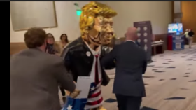 Golden calf? Onlookers bemused as Republicans wheel in gold Trump statue for CPAC