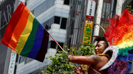A reveler holds a rainbow flag during a parade in Tokyo, Japan, May 8, 2016.