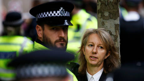 Police officers detain co-founder of the Extinction Rebellion group, Gail Bradbrook, after she was removed from atop the doorway into the Department of Transport, during an Extinction Rebellion protest in London, Britain, (FILE PHOTO) © REUTERS/Henry Nicholls