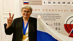 Flag-nificent victory: Checkers queen poses with Russian flag after overcoming tricolor fiasco in dramatic World Championship win