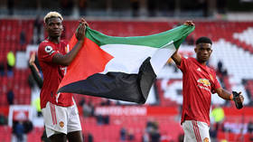 Man Utd star Pogba carries Palestinian flag around Old Trafford as World Cup winner is latest footballer to show support (VIDEO)