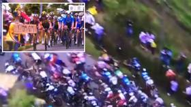 Tour de France fan who caused 21 injuries by triggering mass crash with sign is now being HUNTED BY POLICE (VIDEO)