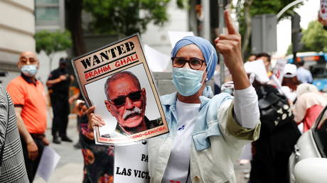 A demonstrator holds a placard during a protest against Brahim Ghali outside Spanish High Court in Madrid, Spain, (FILE PHOTO) © REUTERS/Sergio Perez