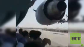 WATCH: Afghan man records video sitting atop FAIRING of US military plane taxiing at Kabul airport