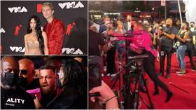 Con the rampage: McGregor hurls drink at rapper Machine Gun Kelly as security forced to step in at MTV awards clash (VIDEO)