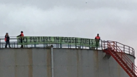 Extinction Rebellion activists blockade then break into UK’s largest oil refinery to roll out ‘no future in fossil fuels’ banner