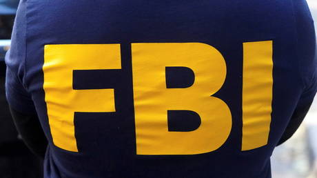 FBI agent stands guard wearing an official jacket