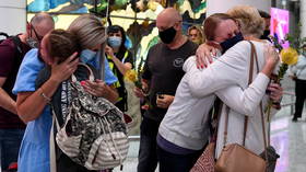 Tearful airport reunions as Australia reopens borders to the vaccinated for first time after almost 600 days of Covid restrictions