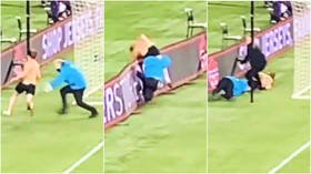 Security guard pulls off ‘perfect tackle’ in brutal takedown of football pitch invader (VIDEO)