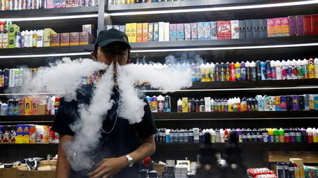 An employee vapes at a vape shop in Jakarta, Indonesia. October 23, 2020. © Reuters / Ajeng Dinar Ulfiana
