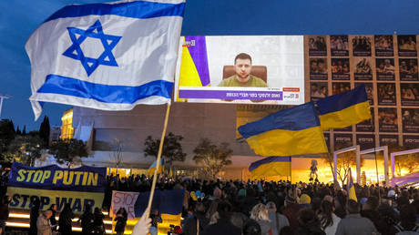 文件图片：2022 年 3 月 20 日，一群人聚集在以色列特拉维夫，观看乌克兰总统泽连斯基向以色列议会发表的电视讲话。