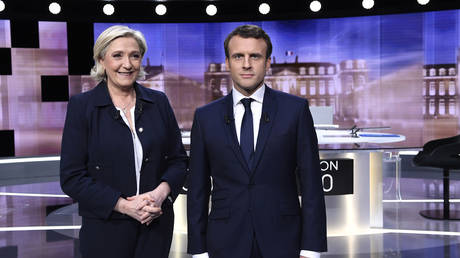 French presidential election candidate for the far-right Front National party, Marine Le Pen, 2nd left, and French presidential election candidate for the En Marche ! movement, Emmanuel Macron, right, Paris, France, Wednesday, May 3, 2017.