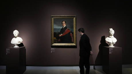 A visitor looks at artwork belonging to the Hermitage Museum, at the Gallerie d'Italia museum, in Milan, Italy, Thursday, March 10, 2022.