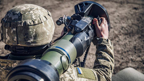 FILE PHOTO. An Ukrainian soldier examines a Swedish-British NLAW portable anti-tank guided missile .
