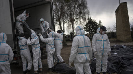 Volunteers load bodies of civilians killed in Bucha in the outskirts of Kiev, Ukraine on April 12, 2022.