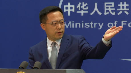Zhao Lijian gestures during a media briefing at the Ministry of Foreign Affairs office in Beijing, China, April 6, 2022 © AP / Liu Zheng