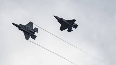 FILE PHOTO: Two US Air Force F-35 Lightning II aircraft fly over the 86th Air Base, Romania, February 24, 2022