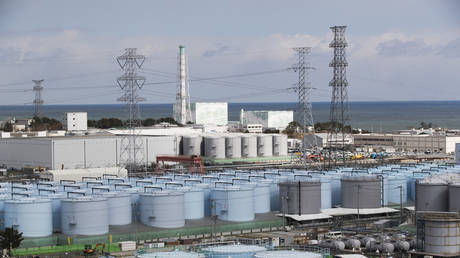 FILE PHOTO: Reactors No. 5 and 6 look over tanks storing treated radioactive water at the Fukushima Daiichi nuclear power plant in Okuma town, February 27, 2021