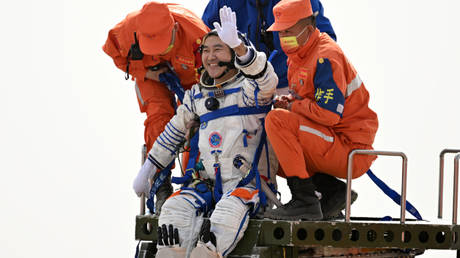 Astronaut Zhai Zhigang waves as he returns from the Shenzhou 13 mission on China's Tiangong Space Station, at a landing site in Inner Mongolia, China, April 16, 2022.