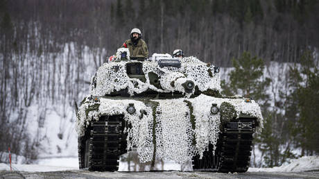 Soldiers from the Norwegian Armed Forces operate a tank during military exercise Cold Response 22 in Norway, on March 22, 2022.