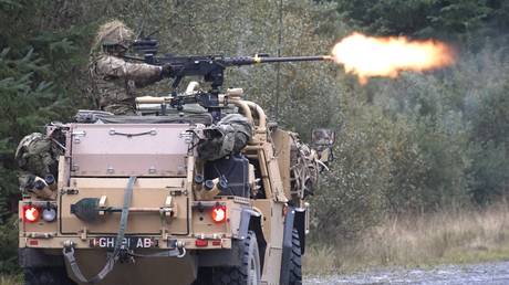 FILE PHOTO: A UK soldier fires a machine from an armored vehicle. © British Army